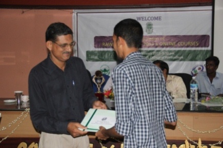 Dr. E. V. Nybe, Director(Academics & PG studies), Kerala Agricultural University, handing over the username & password to Mr. A Abdul Nafiy, an online course participant