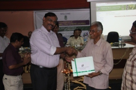 Dr. J. Thomas, Rubber Production Commissioner, Govt. of India, handing over the course module to Mr. M. Parameswaran, the senior most online course participant